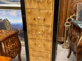 a wooden cabinet with drawers and a mirror in the background