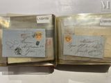 two old envelopes with stamps on them on display