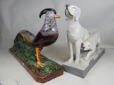 two figurines of a dog and a bird on display