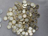 a pile of coins sitting on a table next to a pair of scissors