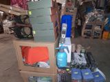 a pile of assorted items on a cart in a garage