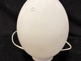 a close up of a white lamp on a black background