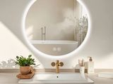 a bathroom with a sink, mirror, and a bathtub