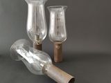 two empty glass vases sitting on top of a table next to each other