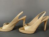 pair of women ' s shoes with high heels on a gray surface