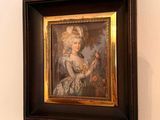 a picture of a woman in a dress hanging on a wall