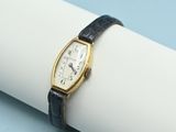a close up of a wrist watch on a napkin on a table