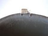 a small piece of wood sticking out of the top of a pan