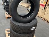 several tires are stacked on pallets in a warehouse