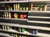 many shelves in the store with canned food on them