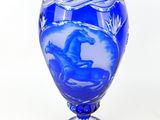 a blue vase with a horse on it on a white background