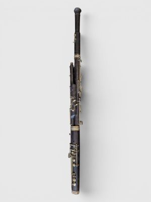a close up of a black and gold flute on a white background