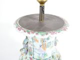 a vase that has a candle on top of it