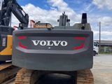 the back end of a volvo excavator parked in a parking lot