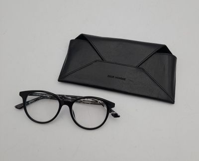 a pair of glasses and a black case on a table