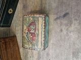 a small box with a painting on it sitting on the floor