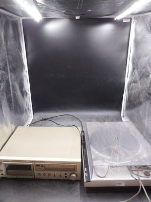 a laptop computer sitting inside of a box in the middle of a room