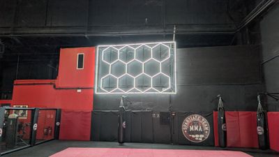 the inside of a gym with a pink floor and red walls