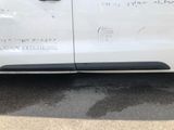 a white van parked in a parking lot with a sticker on the side of the van