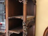 a wooden cabinet with a mirror on top of it