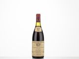 a bottle of wine sitting on top of a white table