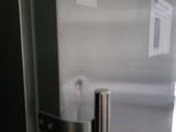 a close up of a stainless steel refrigerator with a number 8 on it
