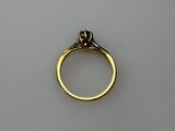 a close up of a gold ring with a diamond on it