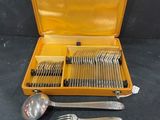a yellow case with silverware in it on a table