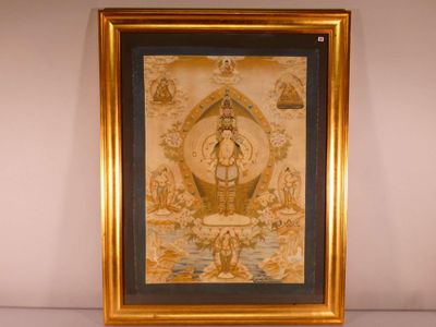 tableau représentant un Bouddha dans un cadre doré, sur un fond blanc