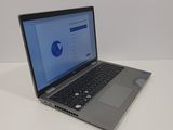 the laptop is sitting on the table with the screen open