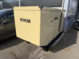 a small generator that is sitting in front of a car