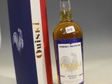 a bottle of alcohol sitting next to a box of wine