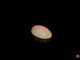an image of a white fire opal in the dark