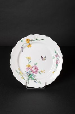 a close up of a plate with flowers and butterflies on it