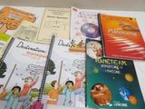 several children ' s books are lined up on a white table