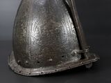 an old helmet is sitting on top of a black table