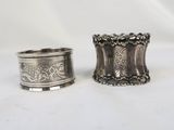 pair of silver napkins with floral design on each of them