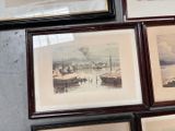 many framed pictures on the wall of a room
