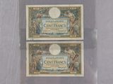 two different types of currency on display in a clear case