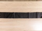 a black belt that is on a wooden table
