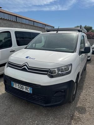 two white vans parked next to each other in a parking lot