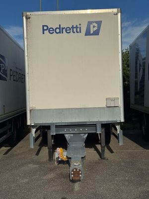 two semi trucks that are parked in a parking lot