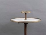 a small round table with a wooden base and a white marble top
