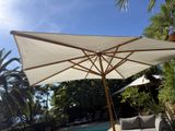 a large umbrella that is sitting on a patio