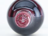 a close up of a wine bottle with a red label