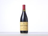 a bottle of red wine sitting on top of a table
