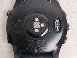 a close up of a watch on a white surface