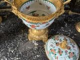 a bowl and a plate on a table with a wallpaper behind it