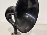 a black gramphone sitting on top of a white table