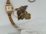 deux montres et une bague exposées dans une vitrine